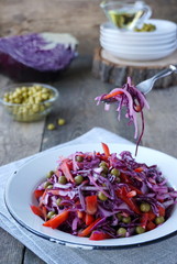 Salad with red cabbage, bell pepper and green peas