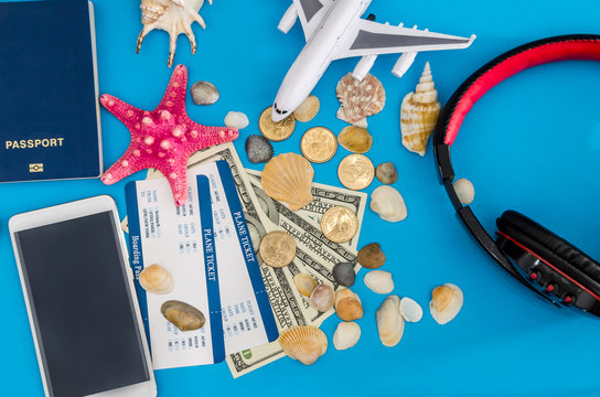 ticket with passport and dolls bills on blue