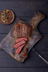 Medium rare steak on cutting board