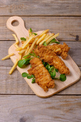 Fried strips chicken breast with french fries