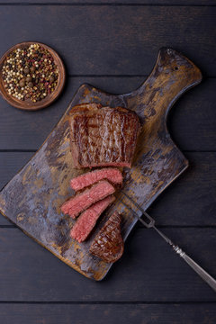 Medium rare steak on cutting board