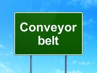 Industry concept: Conveyor Belt on green road highway sign, clear blue sky background, 3D rendering