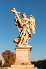 Fototapeta na wymiar Marble statue of angel with cross. Sant Angelo Bridge in Rome. Italy.