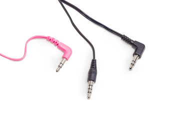 Three different audio plugs with parts of cables