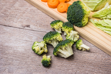 Fresh vegetables from the garden, carrots, cabbage, broccoli, onion and garlic on a wooden table