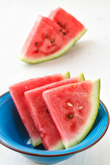slices of ripe watermelon with herbs on white wooden table. Top view