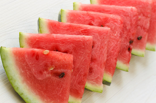 slices of ripe watermelon with herbs on white wooden table. Top view