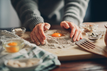 Obraz na płótnie Canvas Close up of woman`s hands making a bread.