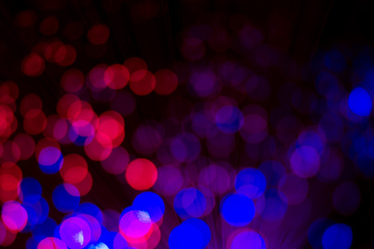 Abstract background with bright colorful dots of light, soft bokeh
