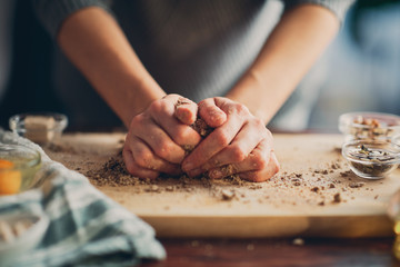 Close up of woman`s hands making a bread.