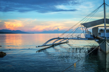 Banka, traditional filipino fishing boat at sunset, Cebu island, The Philippines