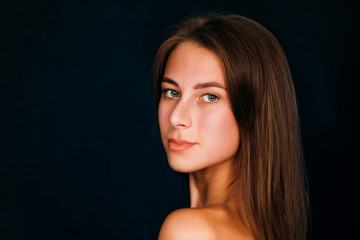 Portrait beautiful girl on a dark studio background