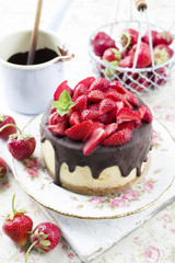 Traditional chocolate strawberry cheesecake with fresh strawberries as top view on a plate