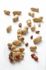 Handful of peanuts in shell on a white table