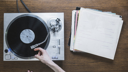 isolated playing turntable with records on the table