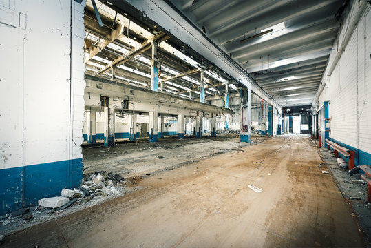 Interior of abandoned industry with dirt and rusty thinghs