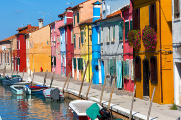 Colorful houses and boats in Burano, Venice Italy.