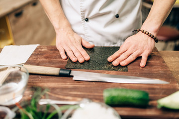 Sushi preparation, traditional japanese food - obrazy, fototapety, plakaty