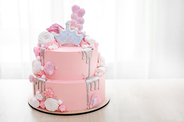 Pink cake decorated with crown of princess