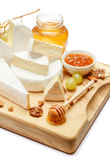 pile of brie or camambert cheese on white background