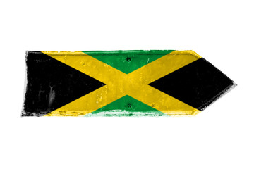 Jamaica flag and colors green, yellow and black over arrow shape from a rusty and grunge metal iron plate with peeling coating and scratches texture isolated on a white background.