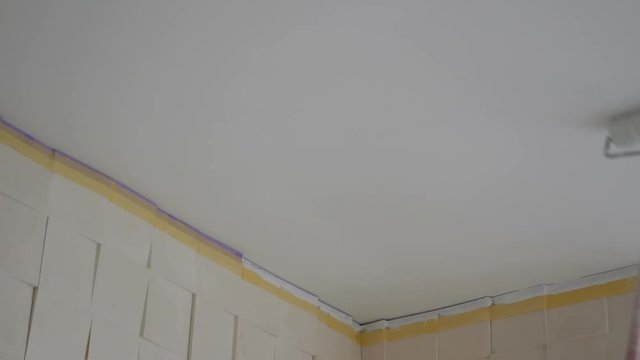 Painting the seiling with paint roller