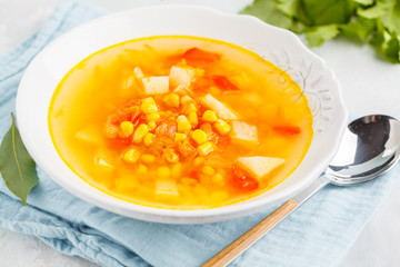 Healthy bright vegetable corn soup in a white plate. Vegan Healthy Food Concept. Top view