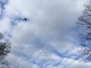 winter sky with clouds and airplane