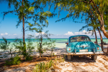 Classic car on a beach in Cuba