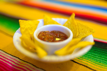 Nachos with mexican salsa sauce on the table
