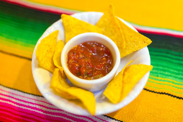 Nachos with mexican salsa sauce on the table