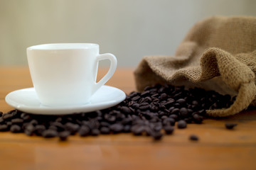 Hot coffee in white cup and coffee beans