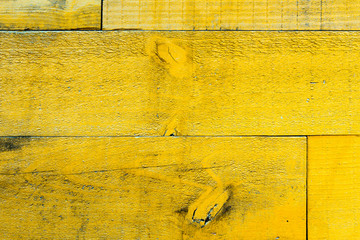 Rustic old grungy and weathered yellow wall wooden planks as wood texture seamless background with natural elements.