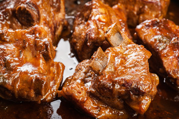 Pork spare ribs on dish in own sauce