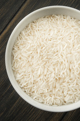 Raw Basmati rice in white porcelain bowl