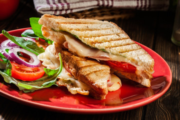 Toasted panini with ham, cheese and tomato sandwich