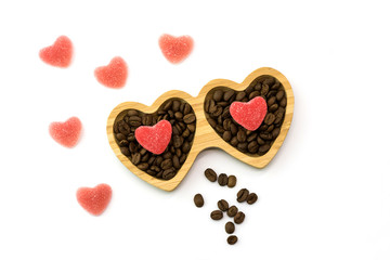 wooden plate with heart candies for St. Valentine's Day and coffee beans, top view