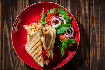 Toasted panini with ham, cheese and tomato sandwich