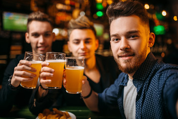 Three men raised their glasses for game victory