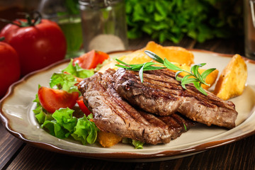 Succulent portions of grilled fillet mignon served with baked potatoes