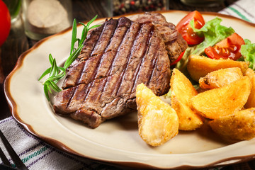Succulent portions of grilled fillet mignon served with baked potatoes