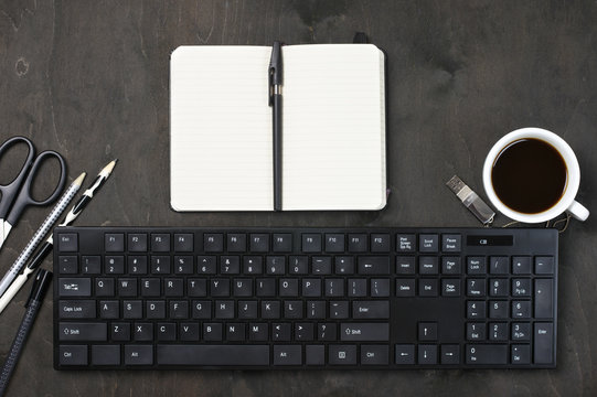 Workplace with keyboard, coffee and stationery