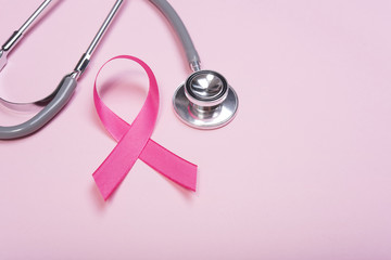 pink ribbon breast cancer and stethoscope on pink background. with copy space
