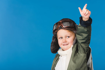 portrait of preteen boy in pilot costume isolated on blue