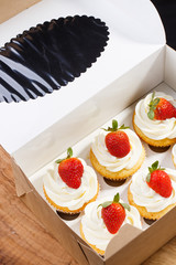 strawberry capcake in a cardboard box
