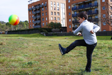 Fototapeta premium Boy kicking a ball