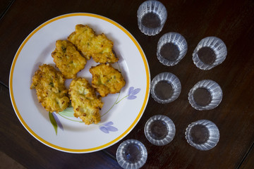 battered potato fritters with near some glasses