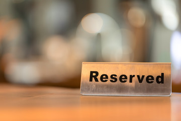 Reserved sign on a wooden table in cafe shop