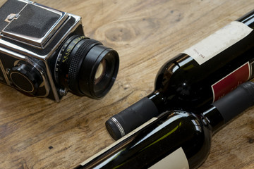 red wine bottles and old camera