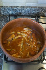 tomato sauce with anchovies cooked in terracotta pot